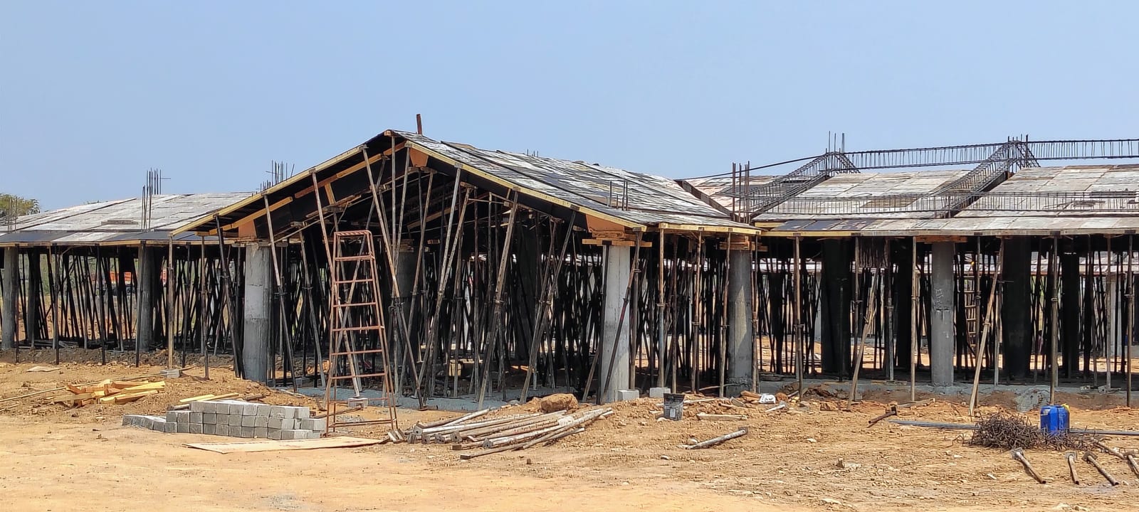 RCC framed pavilion with timber formwork and props during roof casting