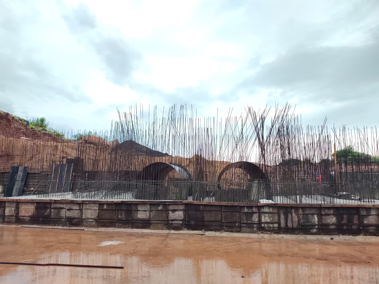 Irrigation structure foundation with reinforcement cages and buried pipes under construction