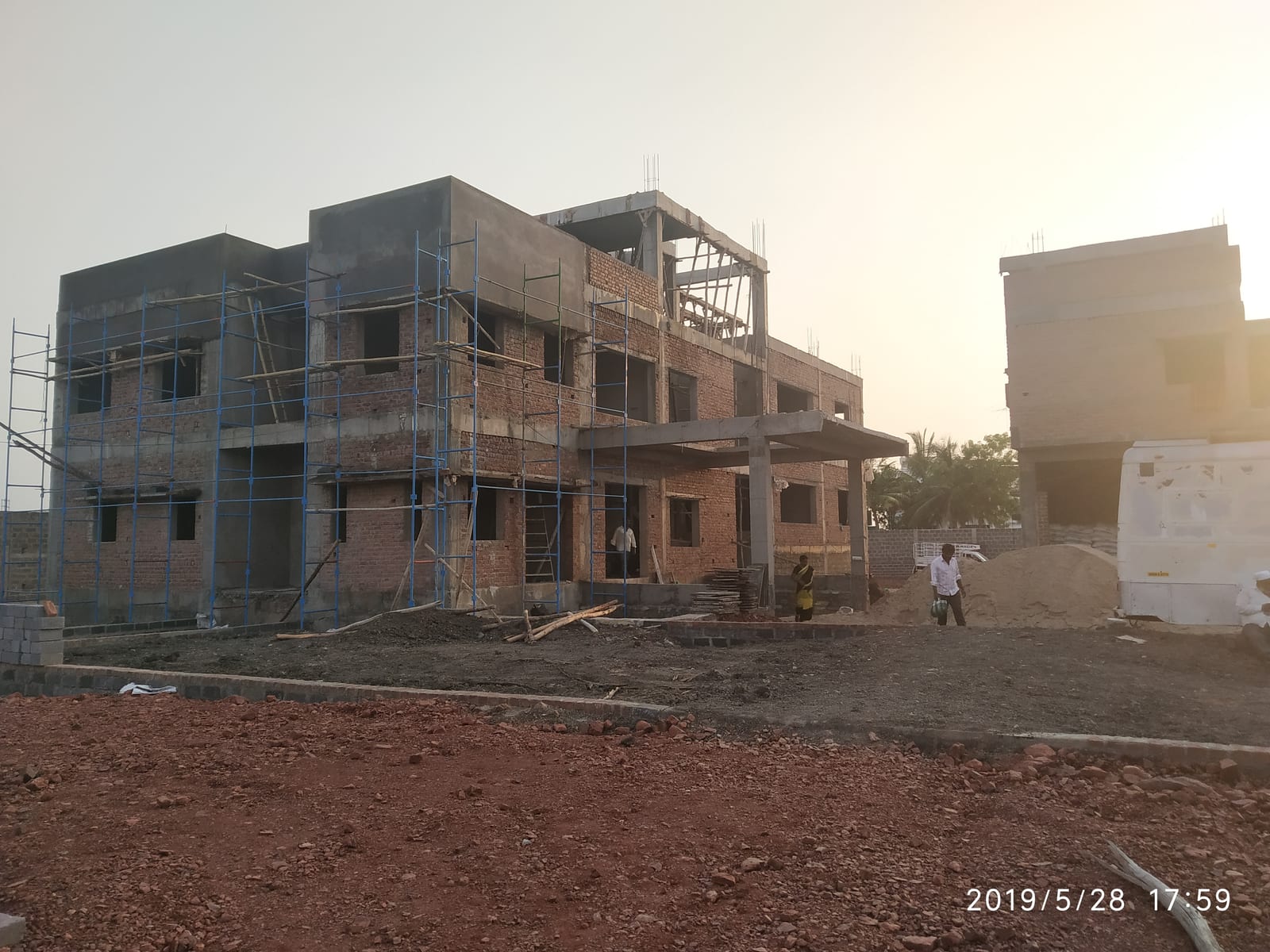 Byreddy House during construction with brick masonry and scaffolding