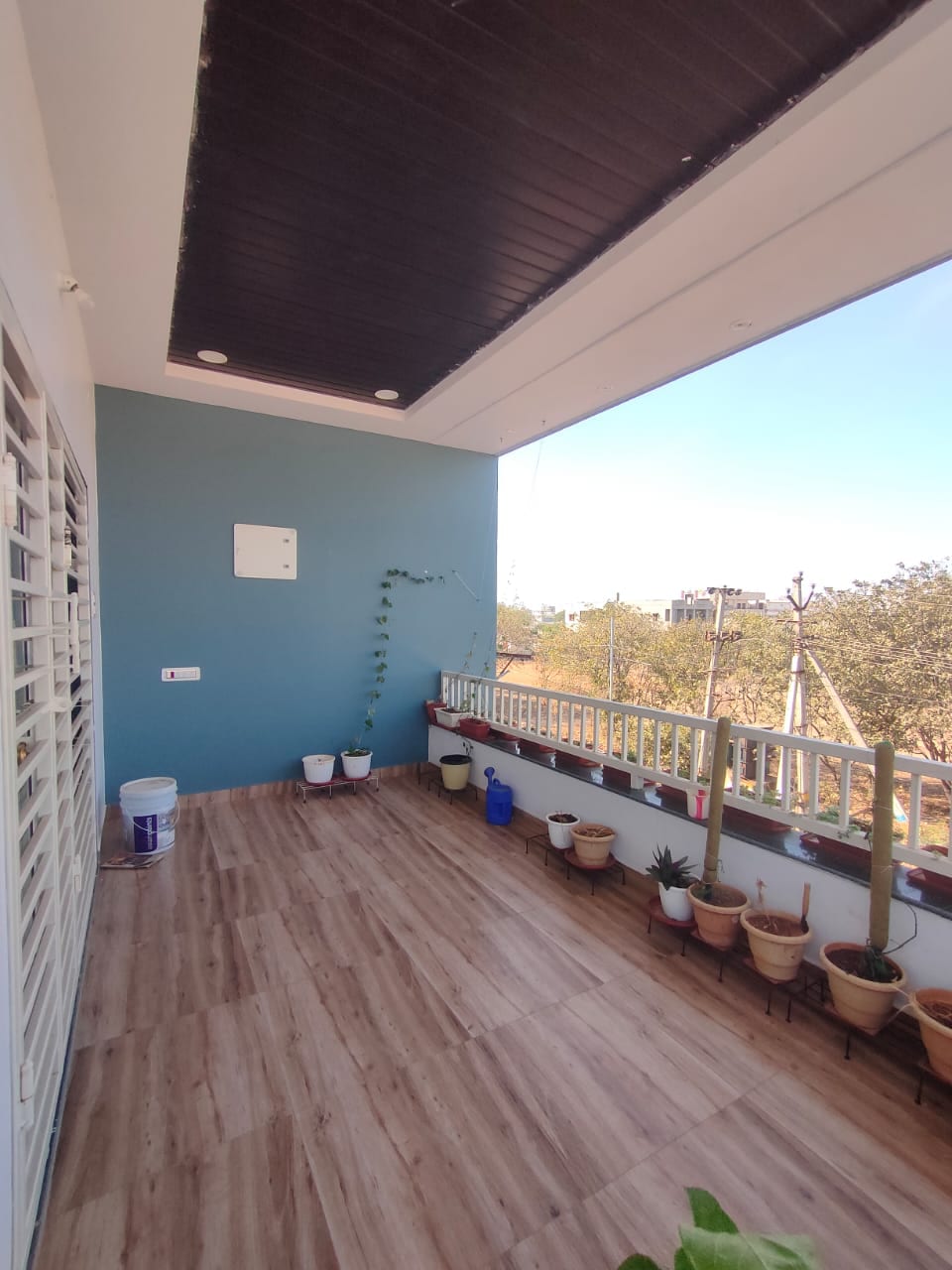 Kurnool Residence finished balcony interior with wood flooring
